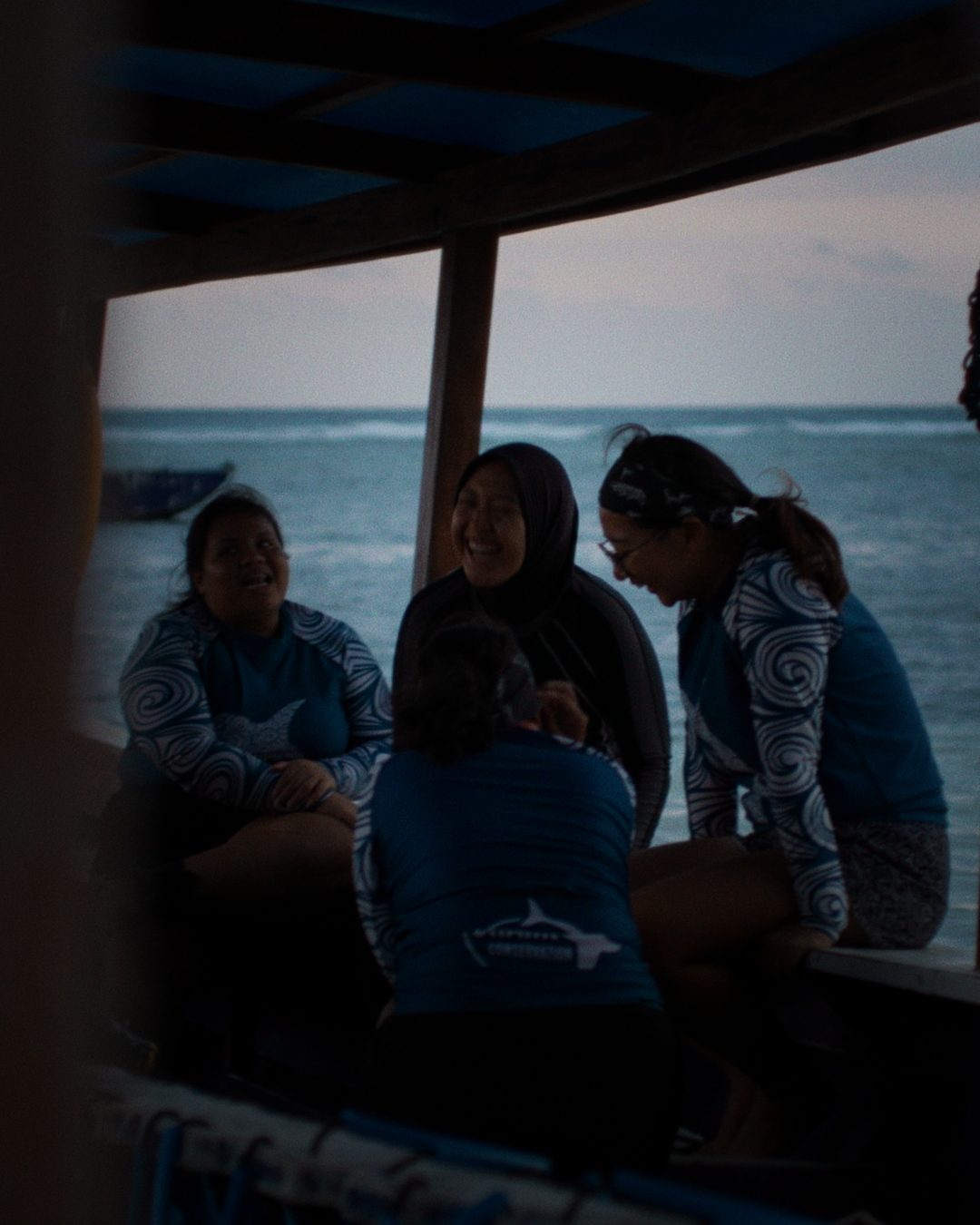 People laughing together by the sea